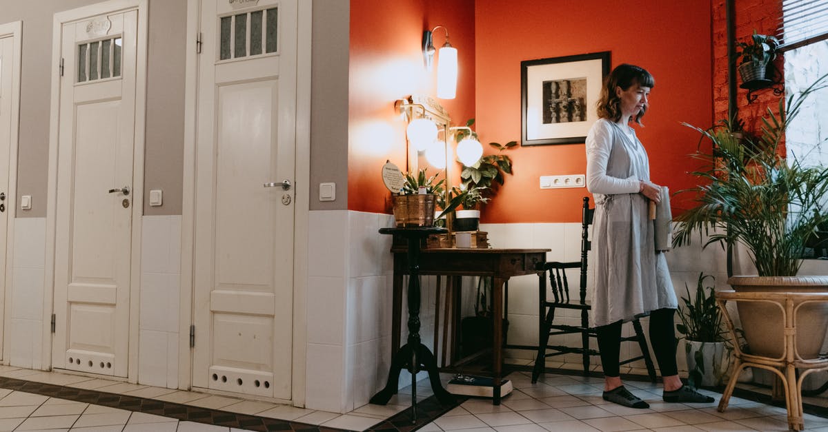 Which botanical gardens can I visit in Shanghai? - Woman in White Robe Standing Beside Brown Wooden Table Which botanical gardens can I visit in Shanghai? - Woman in White Robe Standing Beside Brown Wooden Table