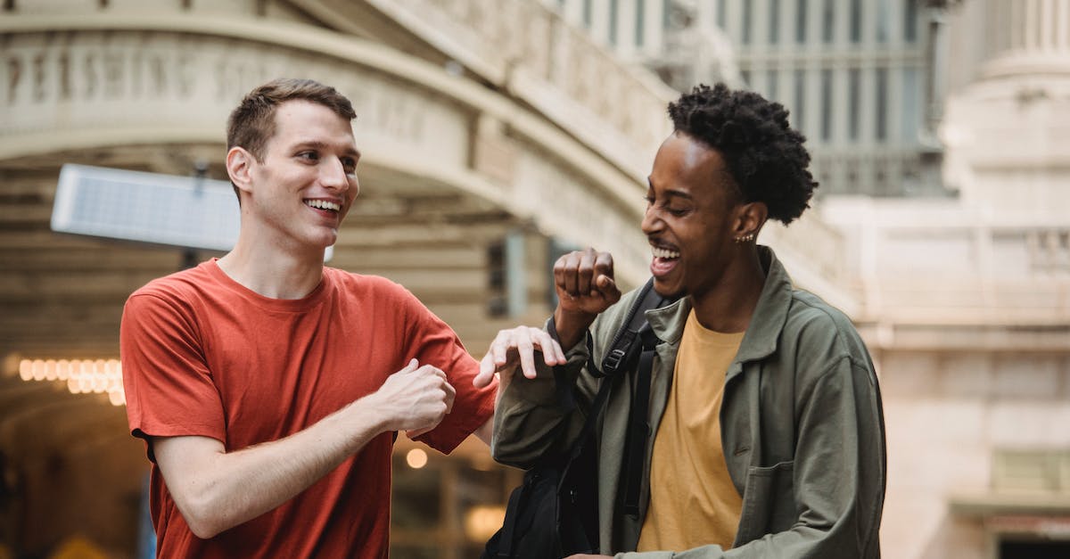 Which Cities In Finland (if any) Have a Medieval Architecture? - Cheerful multiethnic men having fun on street Which Cities In Finland (if any) Have a Medieval Architecture? - Cheerful multiethnic men having fun on street