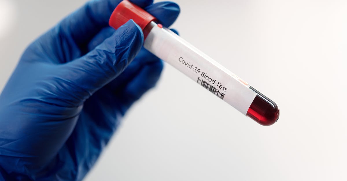 Which countries are allowing visitors to overstay their visas due to the Coronavirus outbreak? [closed] - Person Holding a Covid-19 Blood Test