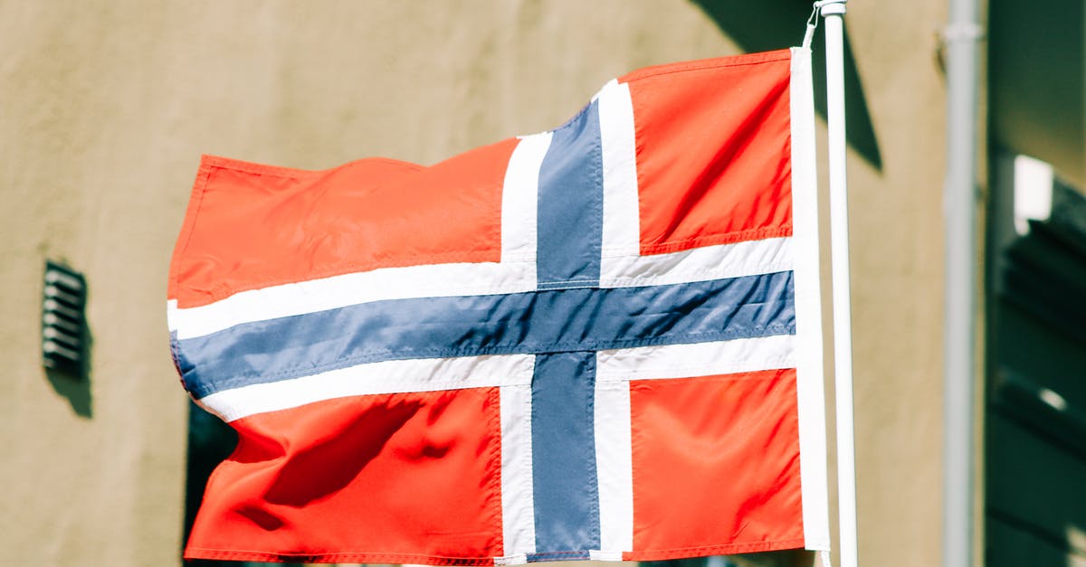 Which country to apply schengen visa when staying for equal number of days in 2 countries and port of entry is 3rd country? [duplicate] - Flag of Norway with white blue and red stripes waving on flagstaff against building