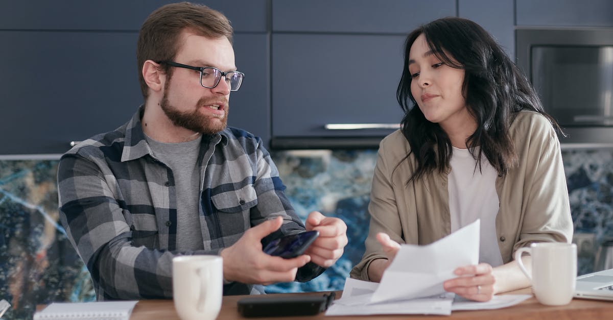 Which documents better to provide for my uk visitor visa? [duplicate] - Man and Woman Sitting at Table