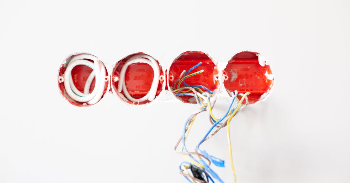 Which EU/UK train companies provide plug sockets, which are free, and on which services? [closed] - Holes on White Wall With Electrical Wires