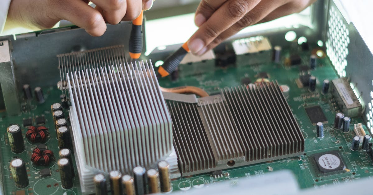 Which frequent flyer card to use? - Crop technician checking contacts on motherboard in workshop Which frequent flyer card to use? - Crop technician checking contacts on motherboard in workshop