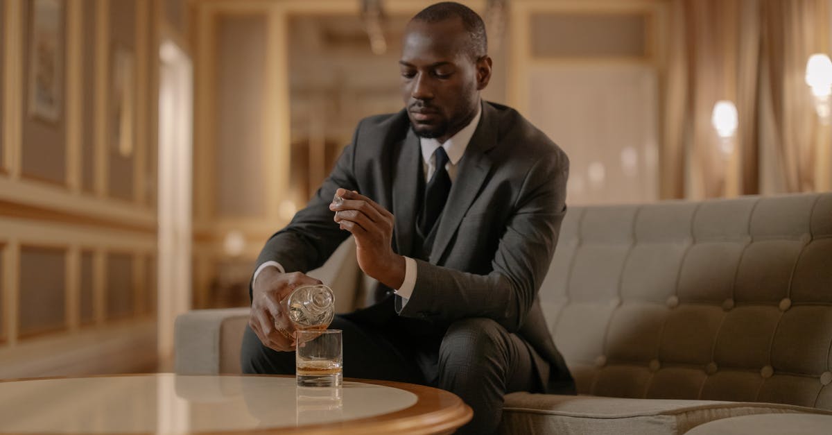 Which hotel chains offer paid membership for their elite status? - Man Pouring Whiskey on His Glass Which hotel chains offer paid membership for their elite status? - Man Pouring Whiskey on His Glass