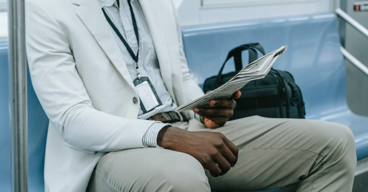 Which is the largest train in terms of passengers? - Man in White Suit Jacket and Gray Pants Sitting on Blue Couch Which is the largest train in terms of passengers? - Man in White Suit Jacket and Gray Pants Sitting on Blue Couch