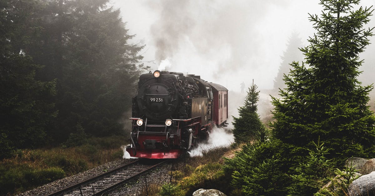 Which is the longest route/train travel possible? - Red and Black Train on Rail Tracks Near Green Trees Which is the longest route/train travel possible? - Red and Black Train on Rail Tracks Near Green Trees