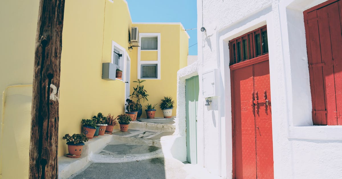 Which is the third most visited Greek island after Santorini & Mykonos? [closed] - Colorful white, red, and yellow street in Santorini, Greece.