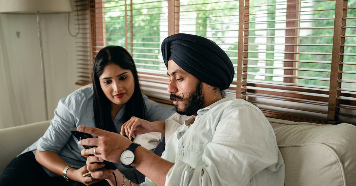 Which kind of visa do I need as an expat online entrepreneur in Thailand? [closed] - Focused young married Indian couple working on project using smartphone while sitting on comfortable couch at home