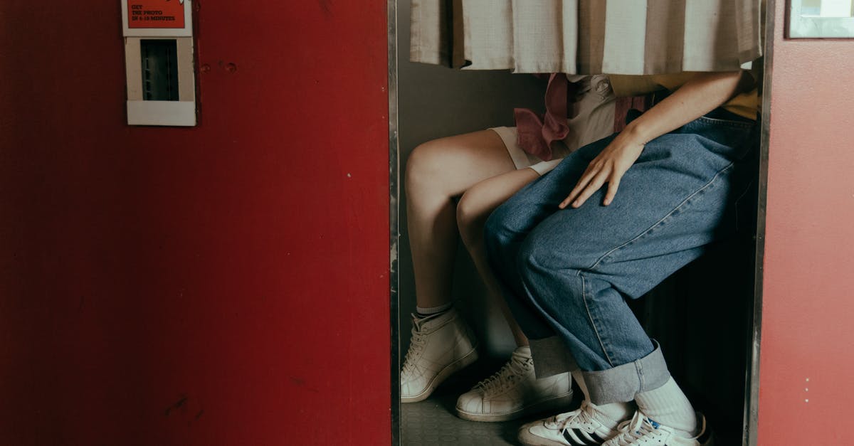 Which photo type I should select in a photo booth for a Schengen Visa? - Woman in Blue Denim Jeans and White and Black Adidas Sneakers Sitting on Black Floor Which photo type I should select in a photo booth for a Schengen Visa? - Woman in Blue Denim Jeans and White and Black Adidas Sneakers Sitting on Black Floor