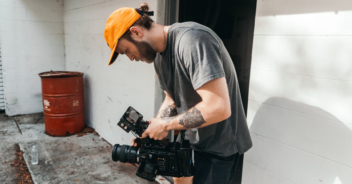 Which place was this video shot in? - Man in Grey Crew Neck T-shirt and Yellow Hat Holding Black Dslr Camera Which place was this video shot in? - Man in Grey Crew Neck T-shirt and Yellow Hat Holding Black Dslr Camera