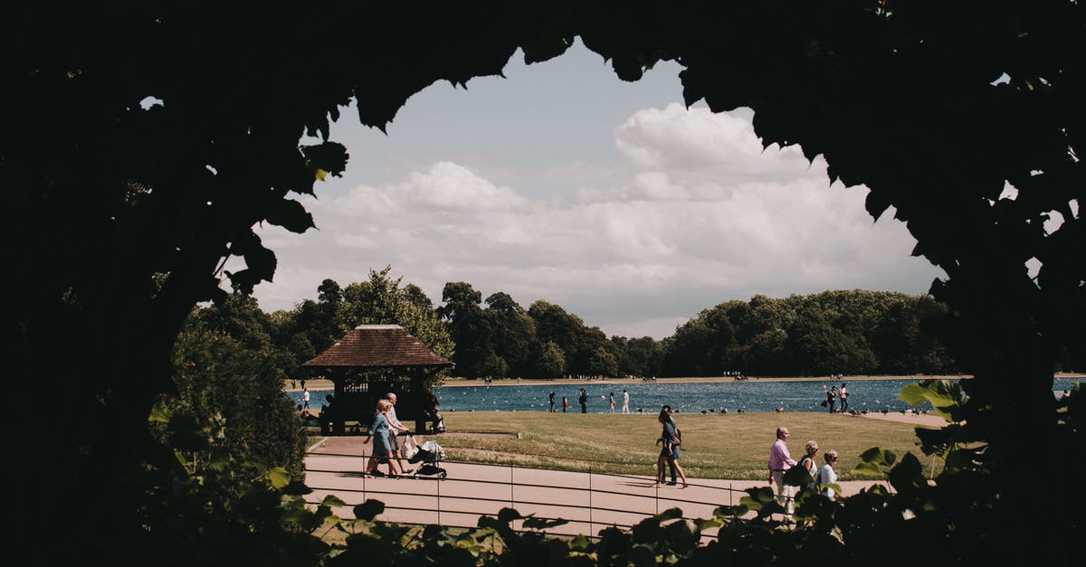 Which street should we take a stroll down to get to the lake from the Thompson Hotel? - People walking on embankment near river Which street should we take a stroll down to get to the lake from the Thompson Hotel? - People walking on embankment near river