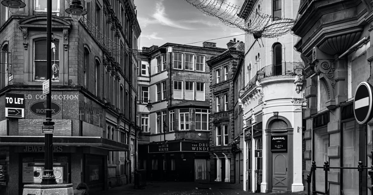 Which UK visa should my dependents apply for? - Grayscale Photo of a Street in Between Buildings Which UK visa should my dependents apply for? - Grayscale Photo of a Street in Between Buildings