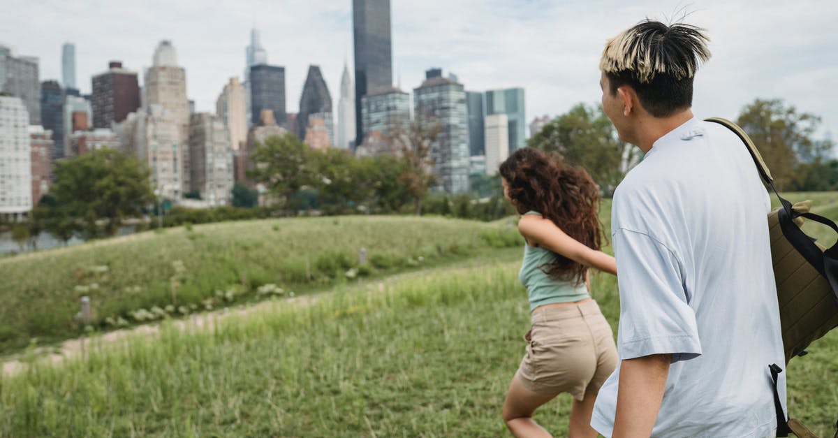 Which US states have criminalized hitchhiking? - Side view of unrecognizable young female tourist holding hand of boyfriend and running in city park during romantic date in New York Which US states have criminalized hitchhiking? - Side view of unrecognizable young female tourist holding hand of boyfriend and running in city park during romantic date in New York
