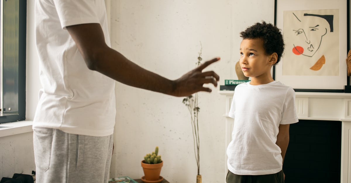 Which vantage point allows to see the Cristo Rendedor with Rio behind it? - Crop unrecognizable black father disciplining adorable attentive son at home Which vantage point allows to see the Cristo Rendedor with Rio behind it? - Crop unrecognizable black father disciplining adorable attentive son at home