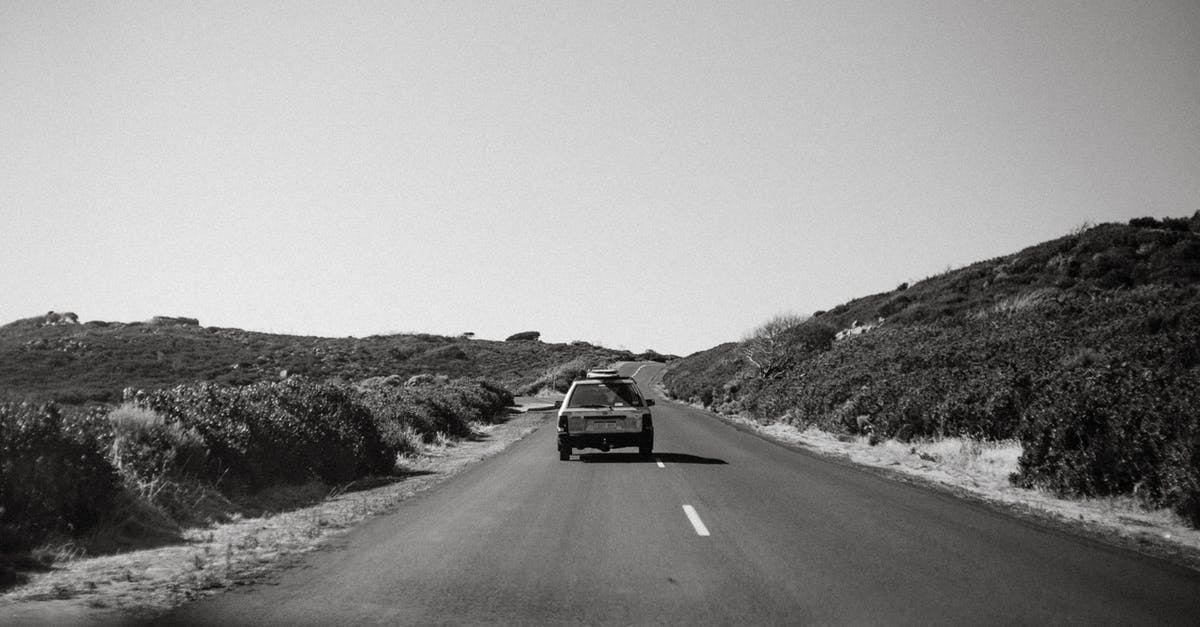 While driving in Europe, can I move into and share a lane next to a motorcycle? [closed] - Car riding on asphalt road