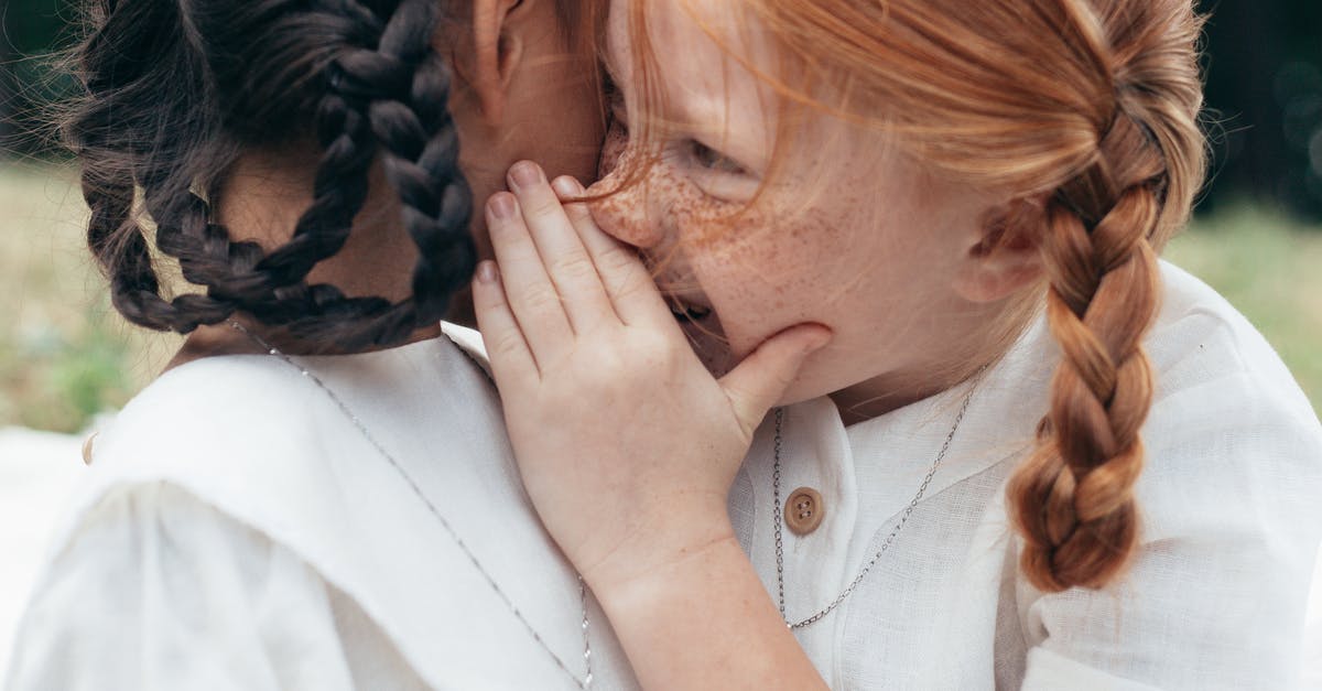 Whispering in other cultures - Girl Whispering to Ear of Another Whispering in other cultures - Girl Whispering to Ear of Another