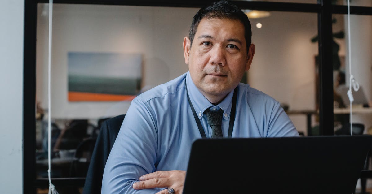 Who is officially responsible for rebooking a missed connection? - Confident ethnic male entrepreneur using laptop during business work in modern workspace and looking at camera Who is officially responsible for rebooking a missed connection? - Confident ethnic male entrepreneur using laptop during business work in modern workspace and looking at camera