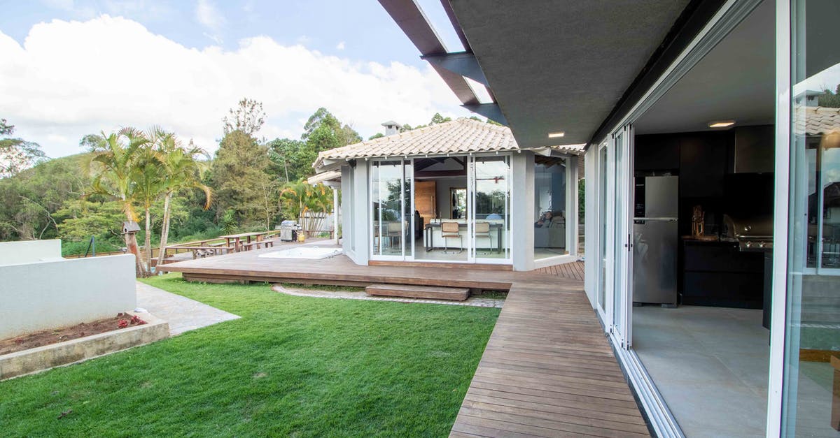 Who is responsible for onward travel after being denied entry to a country? [duplicate] - Inner patio of modern cottage with opened glass doors surrounded by lush palms and tropical plants