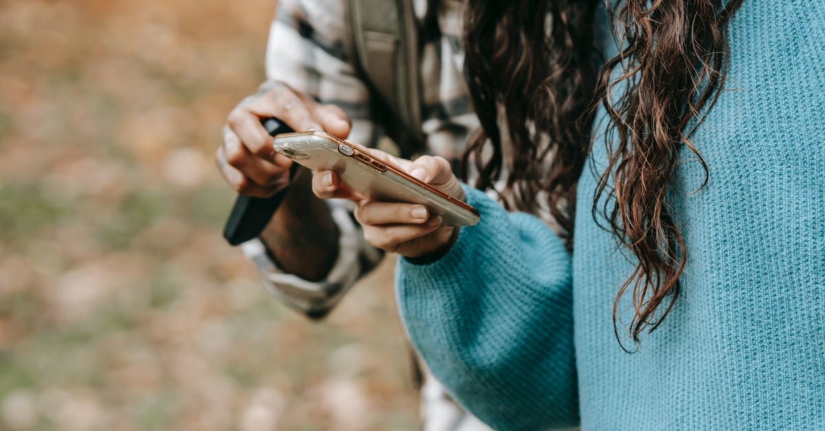 Who to contact about ESTA refusal for previously overstaying partner of US citizen? - Crop anonymous couple in casual clothes standing in fall garden and text messaging on mobile phone