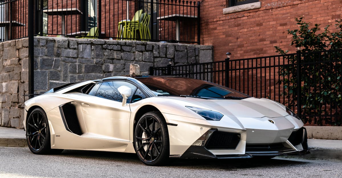 Why are car rentals in Switzerland & Austria so expensive (yet so cheap in Italy)? - White and Blue Lamborghini Aventador Parked Beside Brown Brick Wall Why are car rentals in Switzerland & Austria so expensive (yet so cheap in Italy)? - White and Blue Lamborghini Aventador Parked Beside Brown Brick Wall