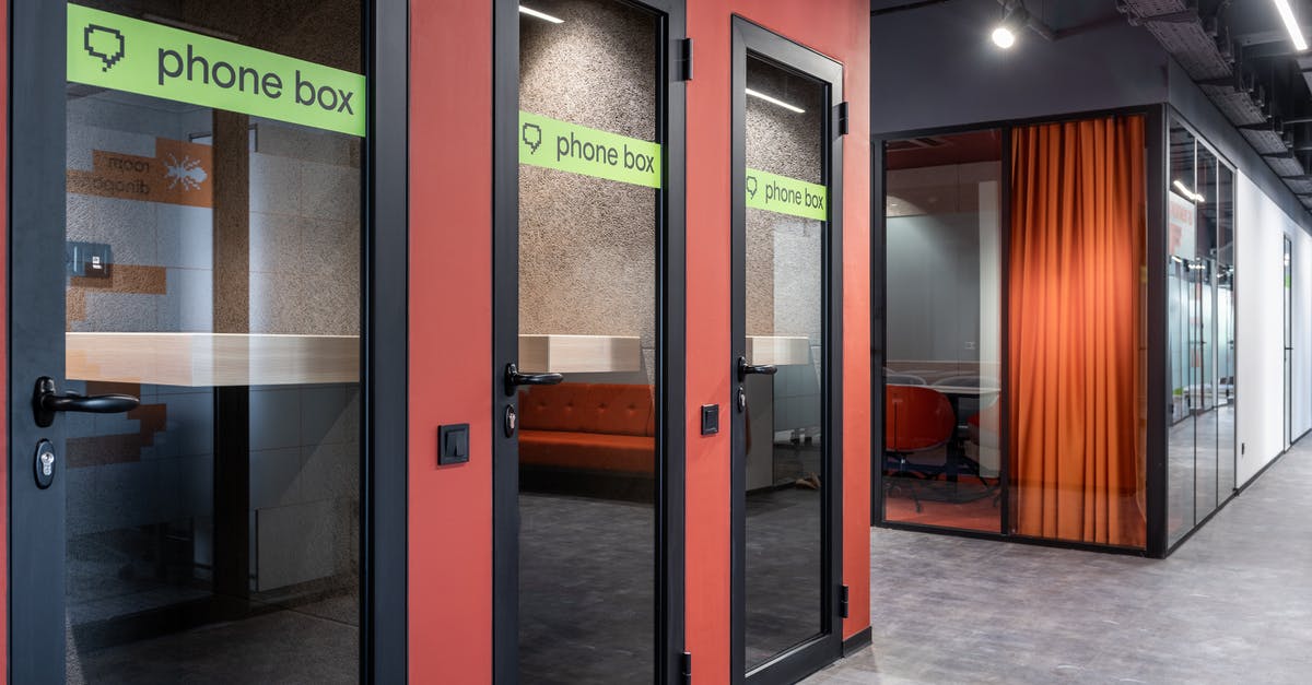 Why are mobile phones prohibited at many consulates? - Spacious corridor with office and phone box Why are mobile phones prohibited at many consulates? - Spacious corridor with office and phone box