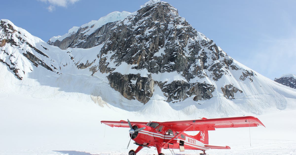 Why are seats near emergency exit on a plane freezing cold? - Red Monoplane in Alps Why are seats near emergency exit on a plane freezing cold? - Red Monoplane in Alps