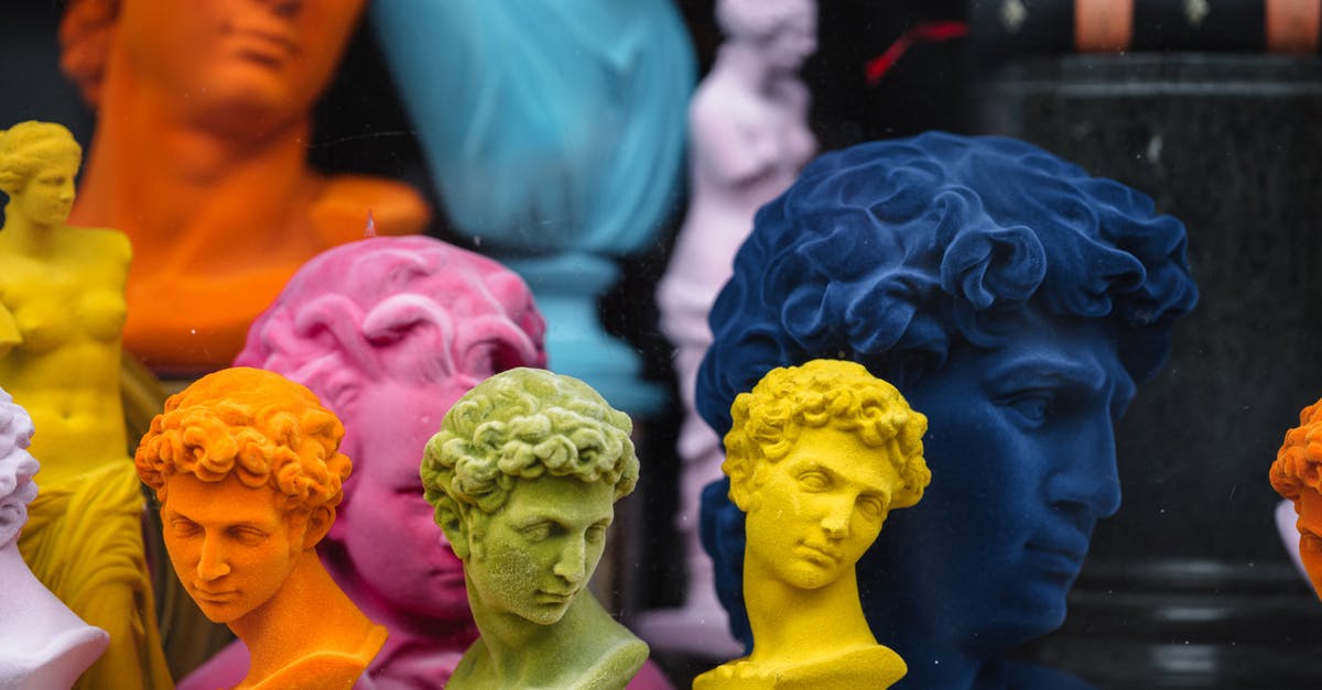 Why are so many airline check-in counters idle so often? - Collection of colorful head sculptures of David in different colors and shapes placed on counter in store with decorative souvenirs Why are so many airline check-in counters idle so often? - Collection of colorful head sculptures of David in different colors and shapes placed on counter in store with decorative souvenirs