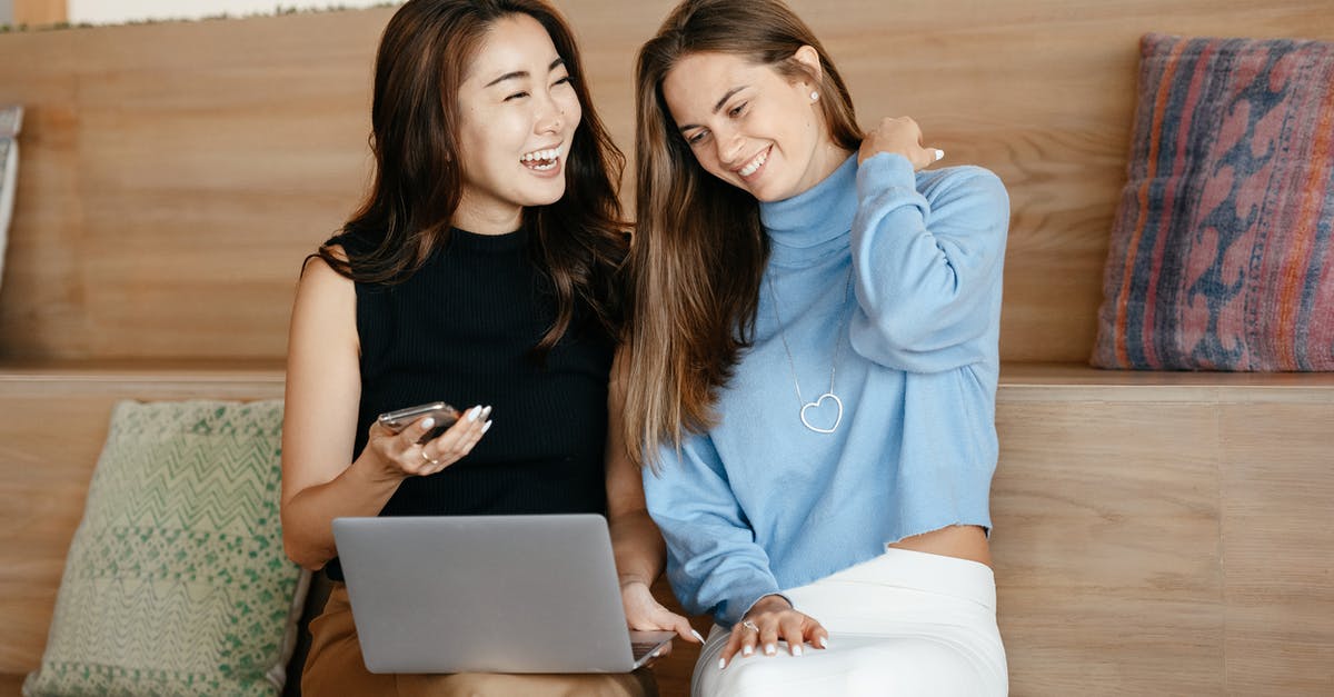 Why are the connecting flights within Azores free? - Cheerful young multiracial friends smiling and surfing internet on netbook while using mobile phone Why are the connecting flights within Azores free? - Cheerful young multiracial friends smiling and surfing internet on netbook while using mobile phone