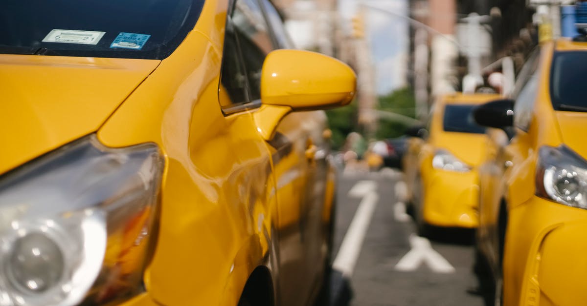 Why are there yellow dot stickers on the front doors of businesses in Russia? - Colorful modern taxi cars on city road Why are there yellow dot stickers on the front doors of businesses in Russia? - Colorful modern taxi cars on city road