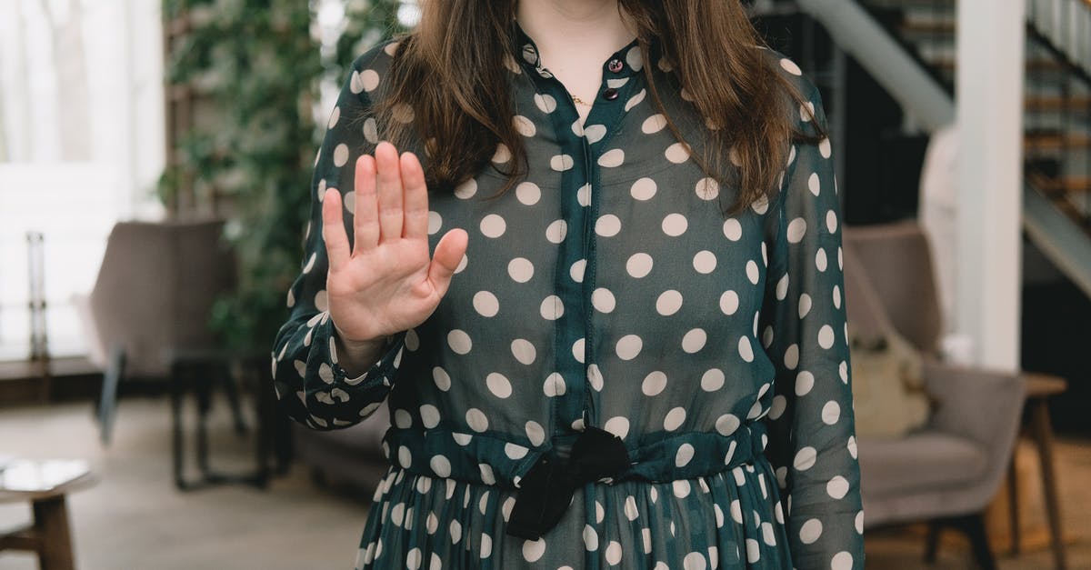 Why aren't UK visa applicants given a chance to explain themselves before getting a refusal? And does one refusal affect other applications? - Crop feminine woman showing stop gesture in modern apartment