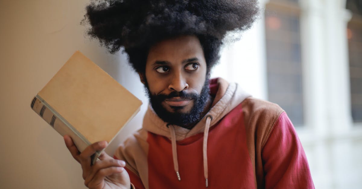 Why booking services never consider MIA for transfers? - Young bearded ethnic male student with creative Afro hairstyle wearing hoodie sweatshirt looking away with doubt expression while taking old book against blurred exterior of aged university Why booking services never consider MIA for transfers? - Young bearded ethnic male student with creative Afro hairstyle wearing hoodie sweatshirt looking away with doubt expression while taking old book against blurred exterior of aged university