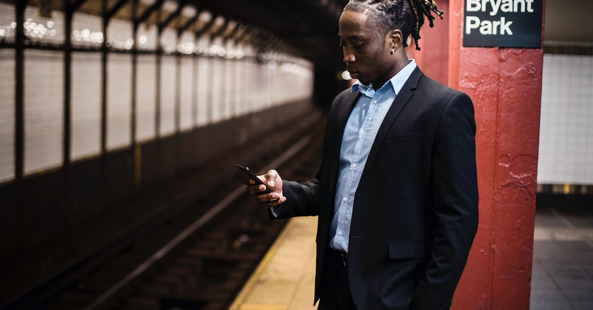 Why do American gas stations' bathrooms apparently use these huge keys? - Modern young African American man in office suit text messaging on cellphone while waiting for train at Manhattan subway station Why do American gas stations' bathrooms apparently use these huge keys? - Modern young African American man in office suit text messaging on cellphone while waiting for train at Manhattan subway station