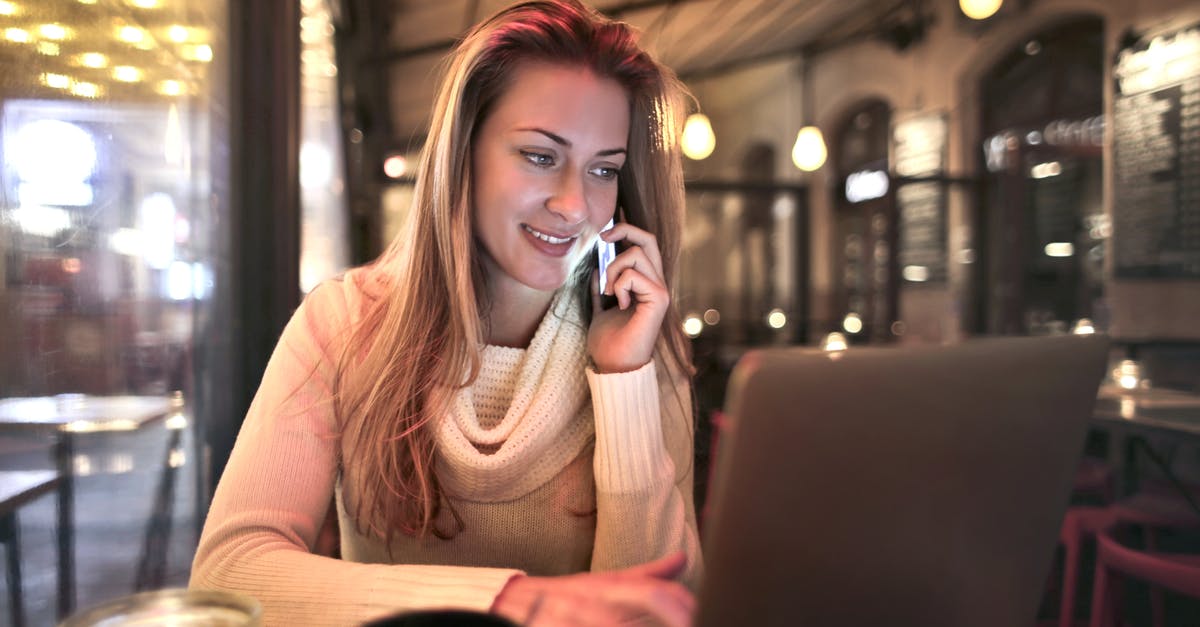 Why do British restaurants call their automatically added service charges anything from "optional" to "discretionary"? - Content female wearing warm sweater sitting at table in cozy cafe and speaking on cellphone while resting in evening and browsing netbook Why do British restaurants call their automatically added service charges anything from "optional" to "discretionary"? - Content female wearing warm sweater sitting at table in cozy cafe and speaking on cellphone while resting in evening and browsing netbook
