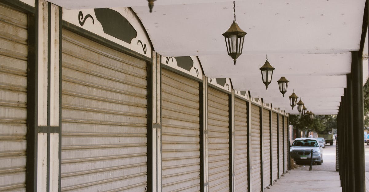 Why do cable cars (gondola lifts) only have doors on one side? [closed] - Wide Angle Photo of Gray Roller Shutters