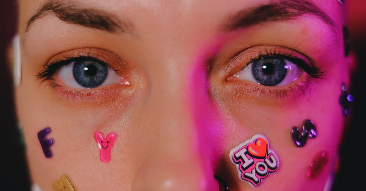 Why do dealers in Vegas check ID even if I look older than 25? [closed] - Crop calm female with nose piercing and letter stickers on face standing on dark background and looking at camera