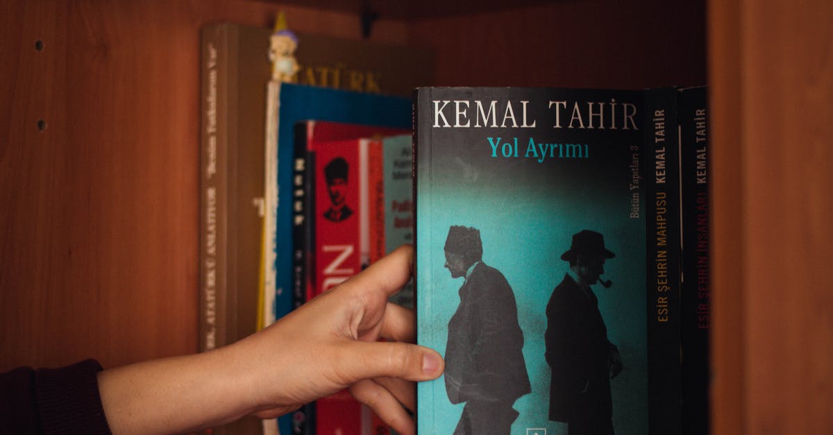 Why do different hotel websites show different prices for the same room? - Crop woman showing book on bookshelf at home Why do different hotel websites show different prices for the same room? - Crop woman showing book on bookshelf at home