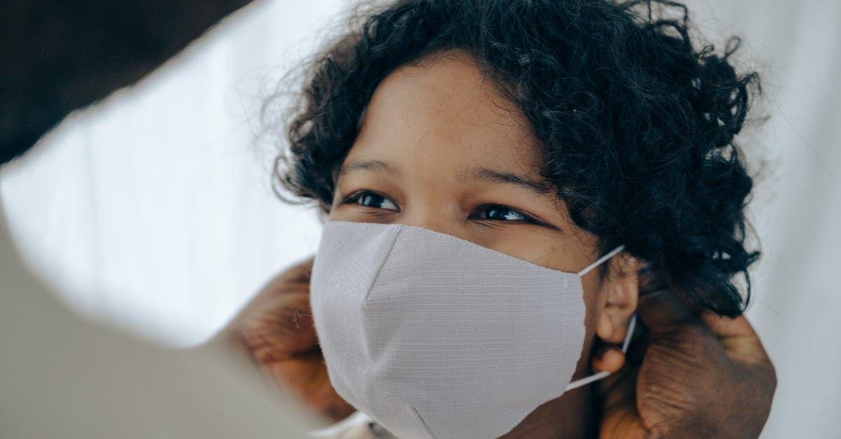 Why do flight attendants say in safety instructions that you should put on your own mask before helping others? - African American man helping positive little son to put protective face mask on during coronavirus outbreak