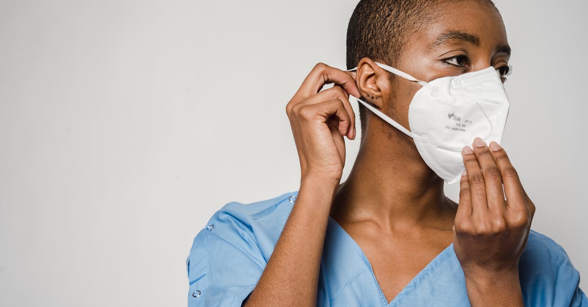 Why do flight attendants say in safety instructions that you should put on your own mask before helping others? - African American female doctor putting on protective mask