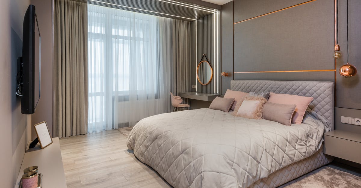 Why do hostels require you to 'rent' bedding? - Stylish bedroom interior with comfortable bed and vanity table Why do hostels require you to 'rent' bedding? - Stylish bedroom interior with comfortable bed and vanity table