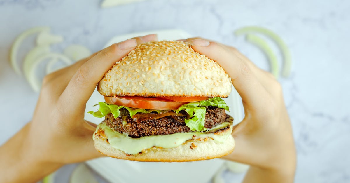Why do people on airplanes often have tomato juice as a drink? - Anonymous person eating hamburger with cutlet and fresh vegetables Why do people on airplanes often have tomato juice as a drink? - Anonymous person eating hamburger with cutlet and fresh vegetables
