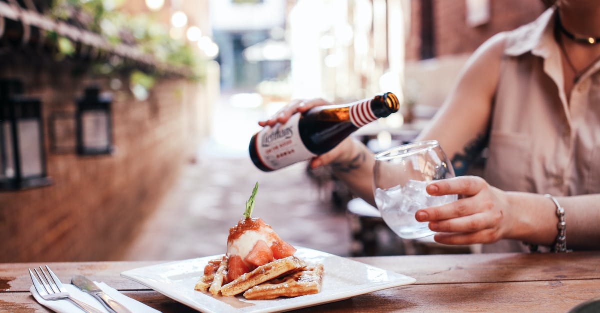 Why do restaurants and cafes in Ukraine make a transaction on each food separately? - Person Pouring Wine on Brown Wooden Table Why do restaurants and cafes in Ukraine make a transaction on each food separately? - Person Pouring Wine on Brown Wooden Table