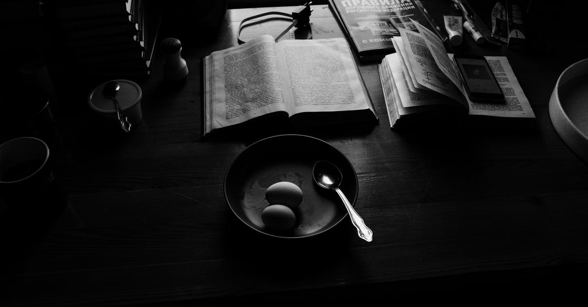 Why do some airlines charge more for break journeys - Black and white of plate with eggs and spoon near opened books and textbook and phone charger placed on wooden desk under light from window Why do some airlines charge more for break journeys - Black and white of plate with eggs and spoon near opened books and textbook and phone charger placed on wooden desk under light from window