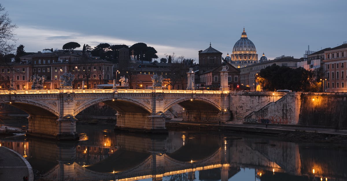 Why does Italy have night open bookstores? - Old urban bridge reflecting in river in evening city Why does Italy have night open bookstores? - Old urban bridge reflecting in river in evening city