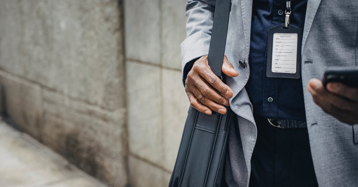 Why does my boarding pass read "APIS OK" - Crop anonymous African American entrepreneur in gray jacket with satchel and pass card browsing internet on smartphone on pavement near stone wall in city in daylight Why does my boarding pass read "APIS OK" - Crop anonymous African American entrepreneur in gray jacket with satchel and pass card browsing internet on smartphone on pavement near stone wall in city in daylight