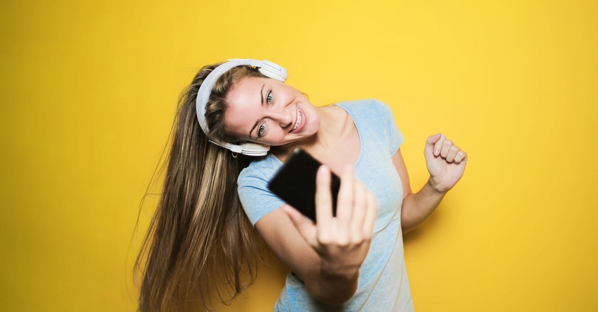 Why does my phone enable camera shutter sounds whenever I insert an Indian SIM? - Satisfied woman taking selfie on smartphone in studio Why does my phone enable camera shutter sounds whenever I insert an Indian SIM? - Satisfied woman taking selfie on smartphone in studio