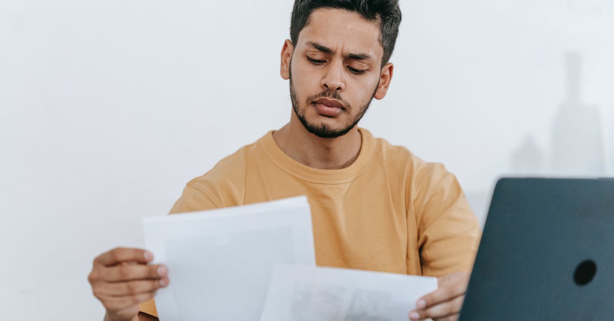 Why does online check-in sometimes close earlier than the offline check-in? - Man looking through documents at workplace Why does online check-in sometimes close earlier than the offline check-in? - Man looking through documents at workplace