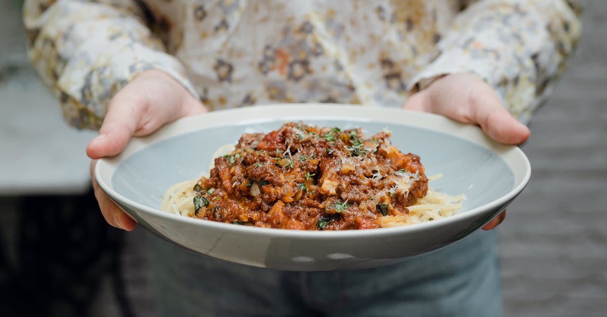 Why don't hotels offer (at least) 1 kitchen bookable by any guest? [closed] - Crop faceless young waitress in casual clothes offering plate of appetizing spaghetti bolognese in bowl