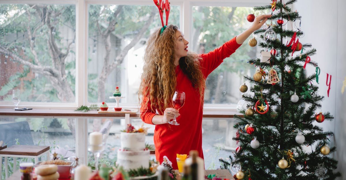 Why has this dress been met with surprise at the Oktoberfest in Munich? - Woman in headband with reindeer decorating Christmas tree Why has this dress been met with surprise at the Oktoberfest in Munich? - Woman in headband with reindeer decorating Christmas tree