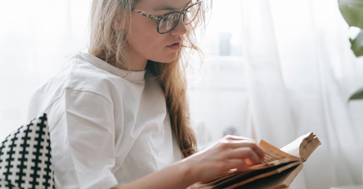 Why have they announced to turn off phones while they are explicitly allowed? - Focused woman flipping page of book Why have they announced to turn off phones while they are explicitly allowed? - Focused woman flipping page of book
