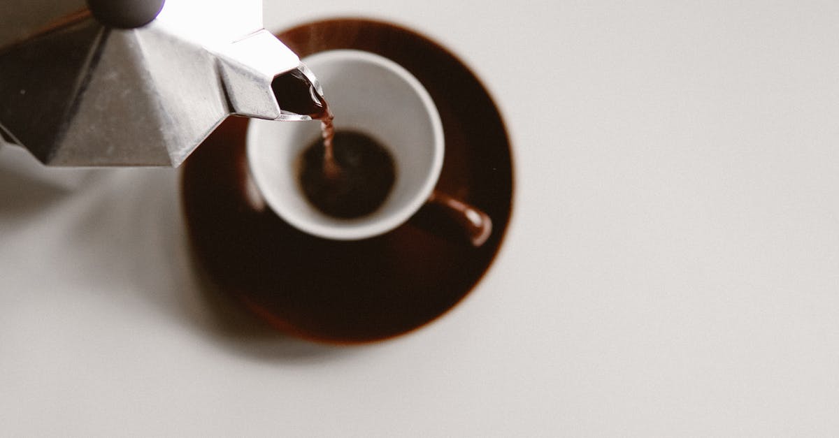 Why is it uncommon to fill airliners from both ends? - From above of geyser coffee maker pouring freshly brewed beverage into ceramic cup placed on white table Why is it uncommon to fill airliners from both ends? - From above of geyser coffee maker pouring freshly brewed beverage into ceramic cup placed on white table